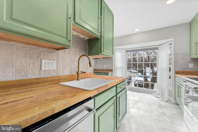 kitchen with tasteful backsplash, sink, stainless steel dishwasher, green cabinets, and range