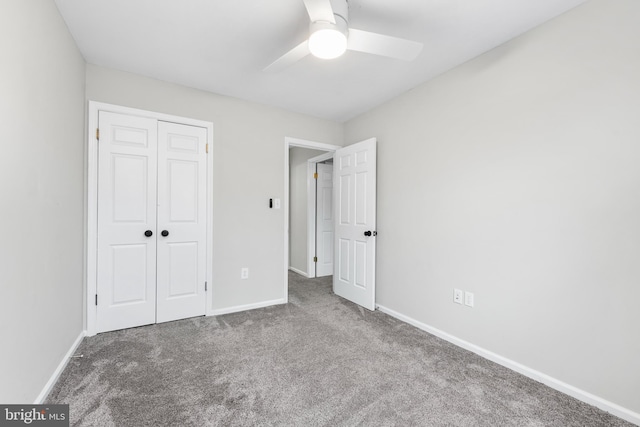 unfurnished bedroom with carpet floors, ceiling fan, and a closet