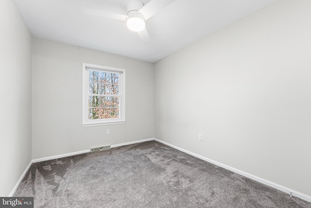 carpeted spare room featuring ceiling fan