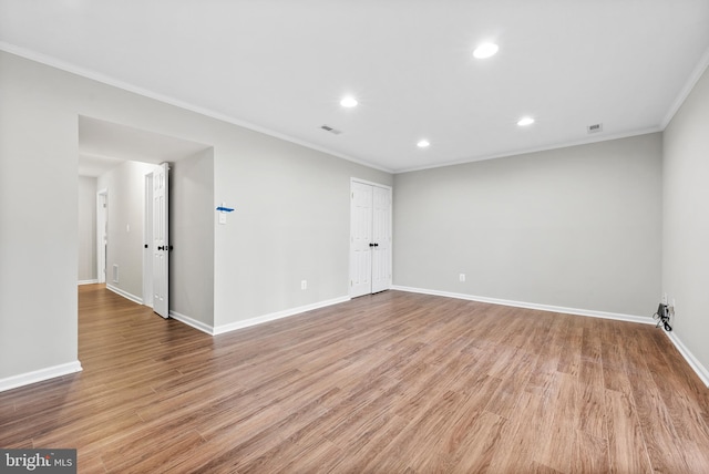 unfurnished room with crown molding and light wood-type flooring