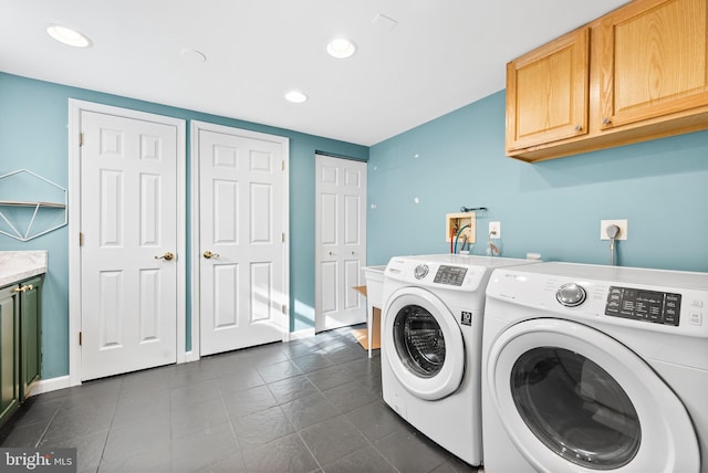 laundry area with washing machine and dryer and cabinets