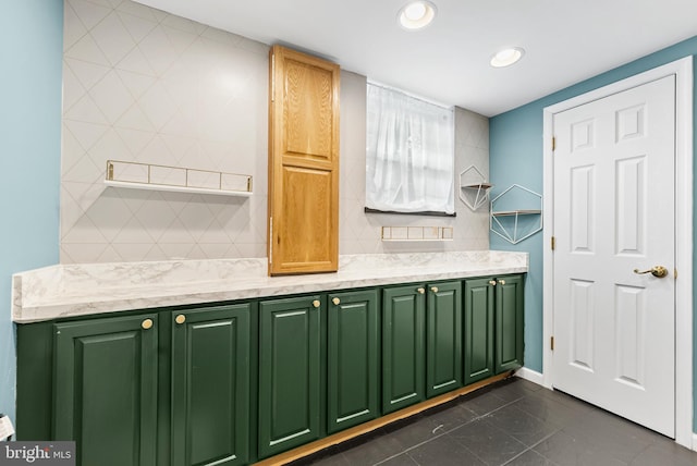 kitchen featuring tasteful backsplash and dark tile patterned flooring