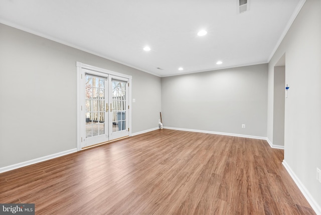 spare room featuring hardwood / wood-style flooring and ornamental molding