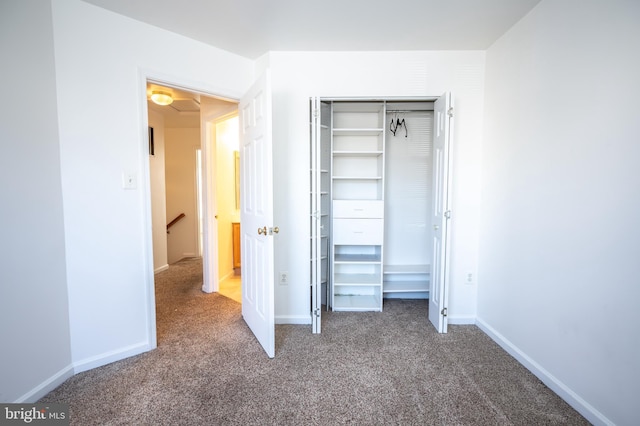 unfurnished bedroom featuring carpet flooring and a closet