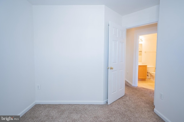 unfurnished room with light carpet