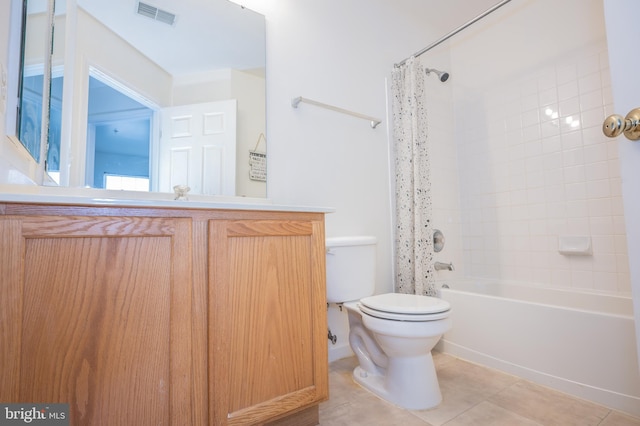 full bathroom featuring vanity, tile patterned floors, shower / bath combo with shower curtain, and toilet