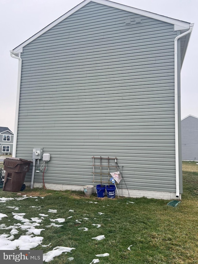 view of side of home featuring a lawn