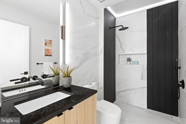 bathroom featuring toilet, a shower, tile walls, and vanity