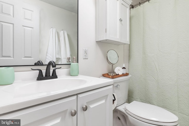 bathroom featuring toilet and vanity