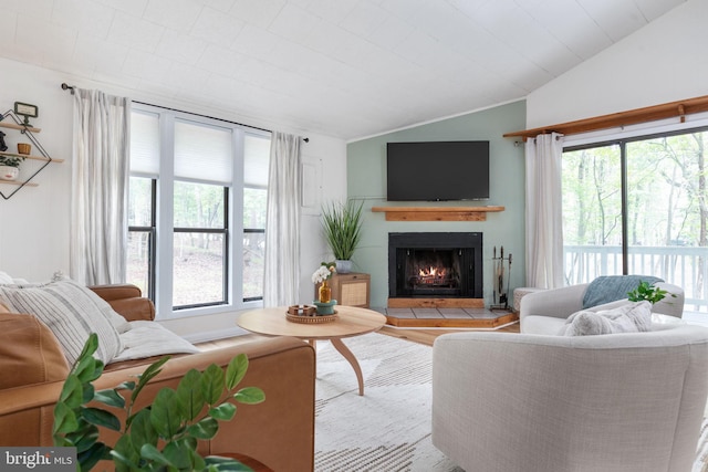 living room featuring vaulted ceiling, light wood-type flooring, and a healthy amount of sunlight