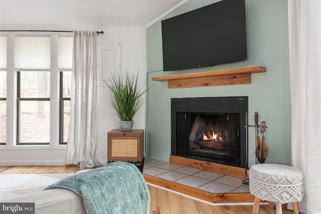 sitting room with a healthy amount of sunlight, crown molding, and hardwood / wood-style floors