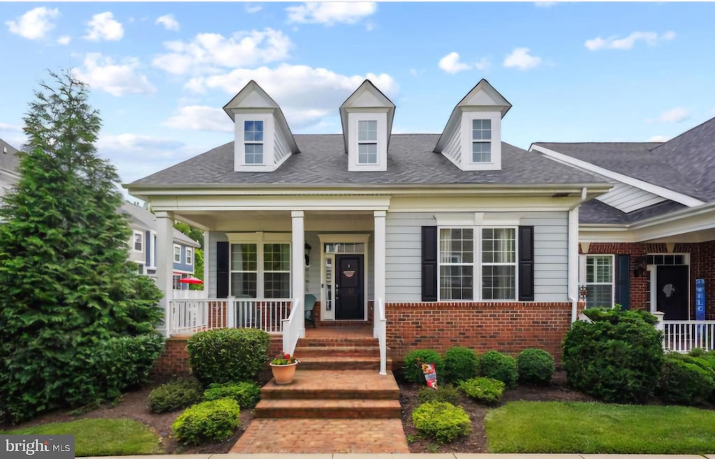 cape cod home with a porch