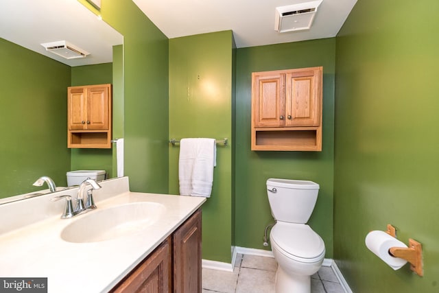 bathroom featuring tile patterned flooring, vanity, and toilet