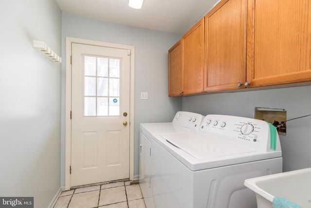 laundry room featuring independent washer and dryer, cabinets, sink, and light tile patterned floors