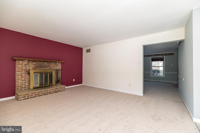 unfurnished living room with carpet floors and a fireplace