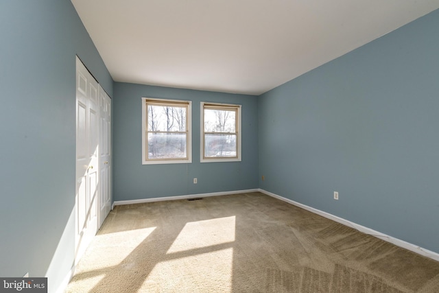 unfurnished bedroom featuring light colored carpet