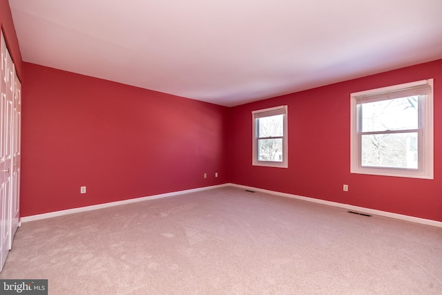 carpeted empty room featuring a healthy amount of sunlight