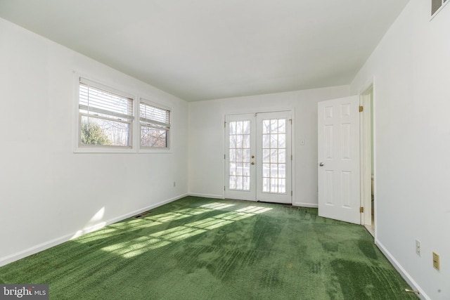 carpeted empty room featuring french doors