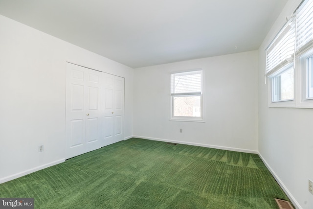 unfurnished bedroom with carpet floors and a closet