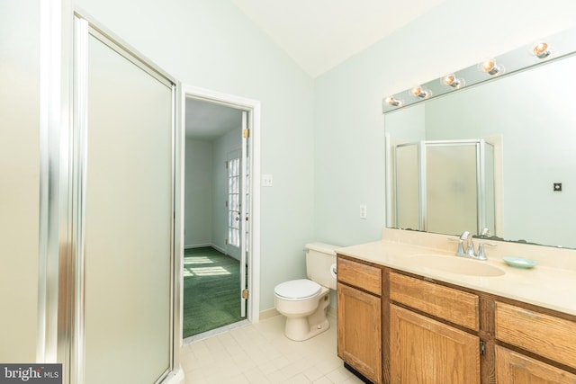 bathroom featuring lofted ceiling, vanity, tile patterned floors, toilet, and walk in shower