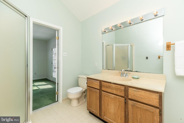 bathroom with a shower with door, vaulted ceiling, vanity, and toilet