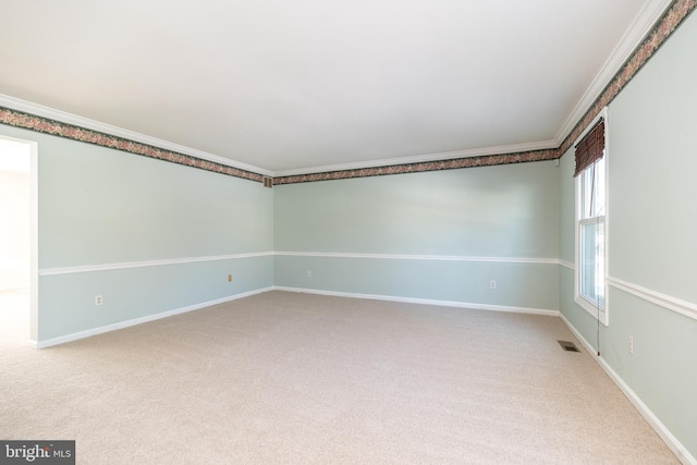 carpeted spare room with crown molding