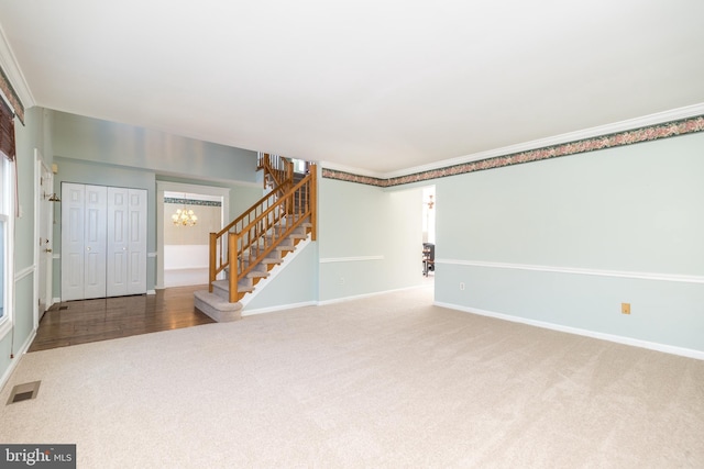 interior space with crown molding, carpet flooring, and a chandelier