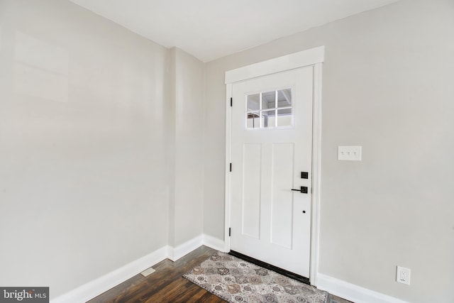 foyer featuring dark wood-style flooring and baseboards