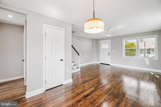 entryway featuring wood-type flooring, stairs, and baseboards