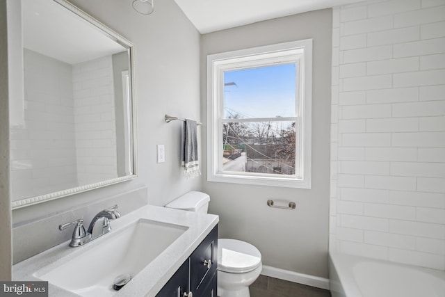 bathroom featuring toilet, baseboards, and vanity