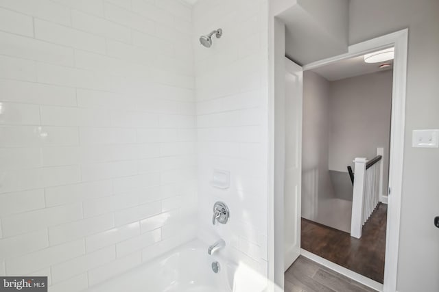 bathroom with shower / washtub combination and wood finished floors