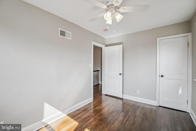 unfurnished bedroom with ceiling fan, wood finished floors, visible vents, and baseboards