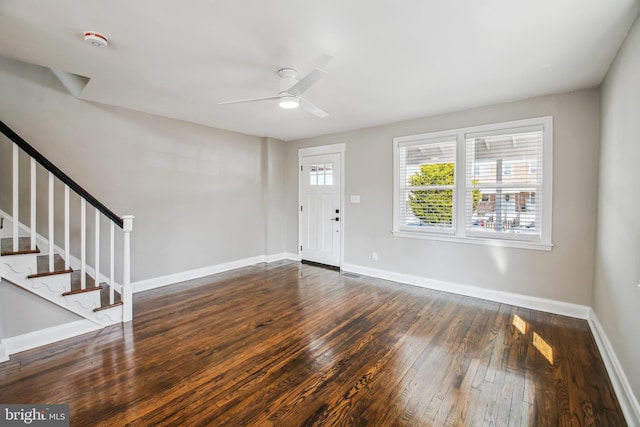 foyer featuring hardwood / wood-style flooring, stairs, baseboards, and a ceiling fan