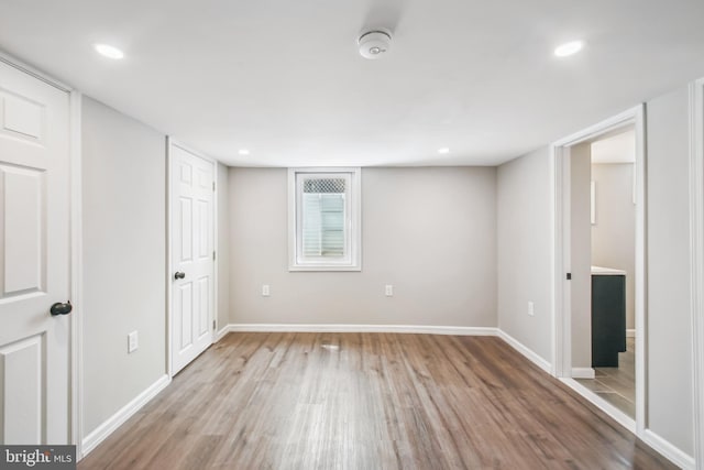 below grade area featuring baseboards, wood finished floors, and recessed lighting