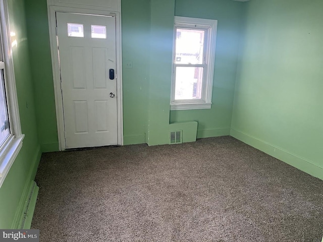 carpeted entryway featuring a baseboard radiator