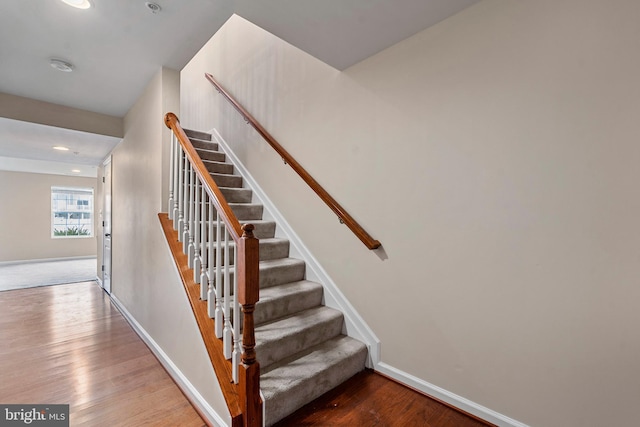 stairway featuring hardwood / wood-style flooring