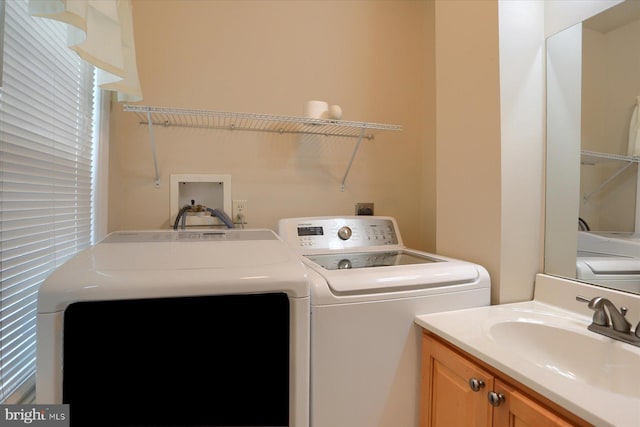 laundry area with washer and clothes dryer and sink