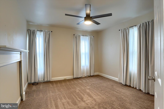 carpeted empty room featuring ceiling fan