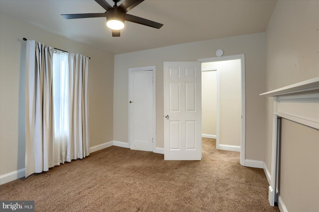 interior space with light carpet and ceiling fan