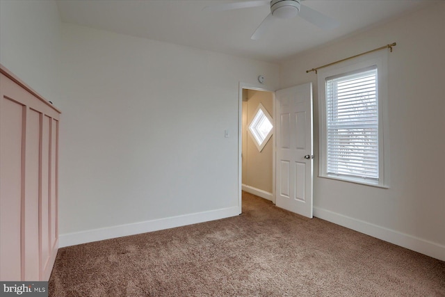 additional living space with ceiling fan and carpet