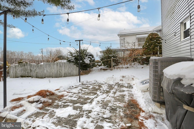 yard layered in snow with central AC