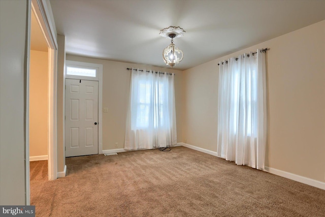 unfurnished room with light carpet