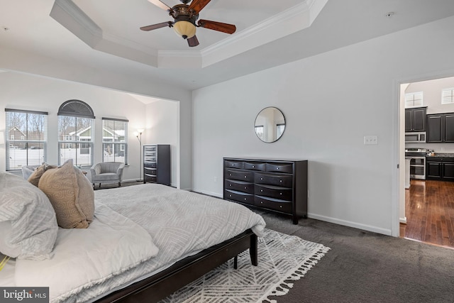 carpeted bedroom featuring ceiling fan, crown molding, and a raised ceiling