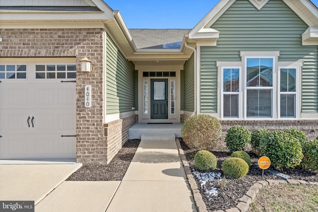 doorway to property with a garage