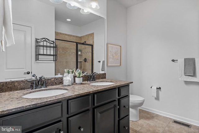 bathroom with toilet, a shower with shower door, and vanity