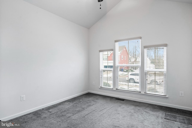 empty room featuring carpet floors, high vaulted ceiling, and ceiling fan