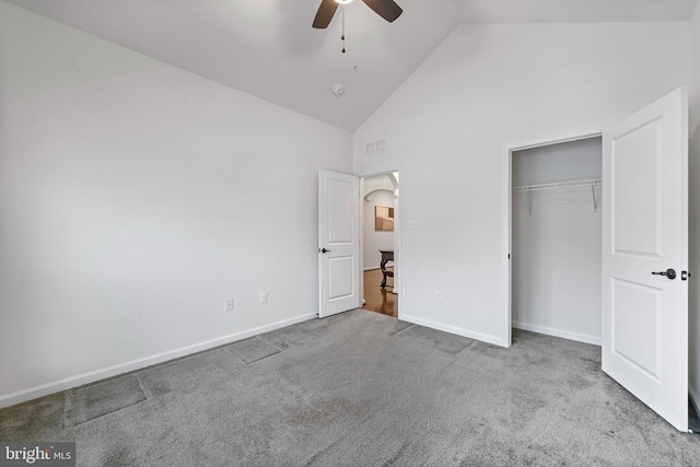 unfurnished bedroom with a closet, ceiling fan, high vaulted ceiling, and light colored carpet