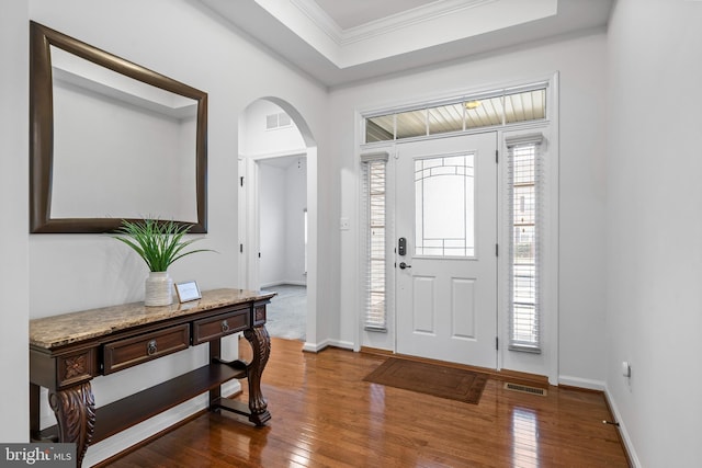 entryway featuring hardwood / wood-style floors and crown molding