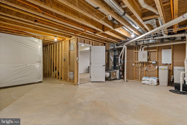 basement featuring heating unit and water heater