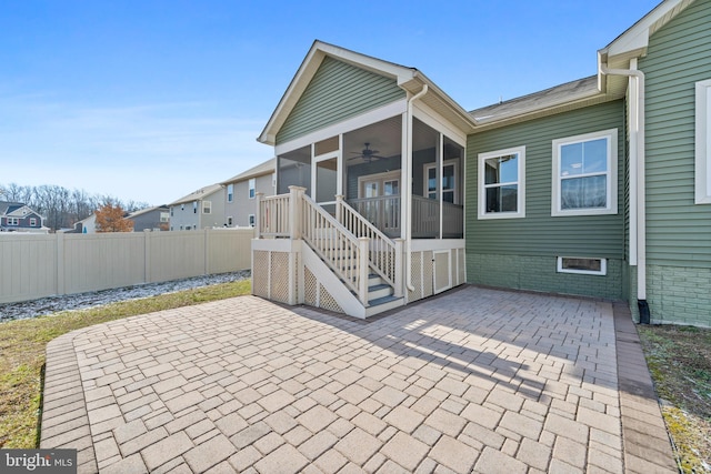 back of house featuring a sunroom, a patio area, and ceiling fan